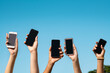 © Rido - Group of hands showing smartphone with copy space