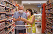 © studio GDB - A senior couple shopping at the market with protective masks