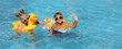© New Africa - Happy children with inflatable rings in outdoor swimming pool on sunny summer day