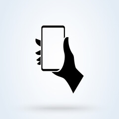 Wall Mural - phone in a man's hand sign icon or logo. Mobile phone in hand concept. holding smart mobile phone vector illustration.