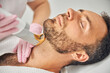 © Svitlana - Handsome bearded man having laser hair removal procedure