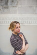 © Giorgio Magini/Stocksy - Serious Young Woman Posing in front of an Old Plaster Wall in It