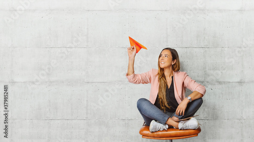 Cuadros en Lienzo Young beautiful woman holding hand model paper air plane