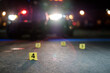 © Riley JB/Stocksy - Shell casings are marked with evidence tags at a crime scene