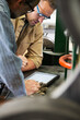 © Jetta Productions/Stocksy - Factory workers looking at digital tablet