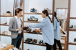 © VisionPro - Details seller lady in a shoe shop discussing with a customer about the shoes he wants to buy