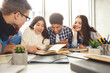 © Prostock-studio - College students in cooperation with their assignment at library