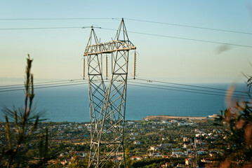 High voltage post or High voltage tower, view of city on background