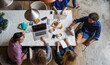 © Jovo Jovanovic/Stocksy - Overhead view of a small group of digital nomads working together