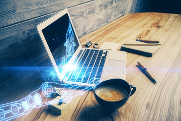 Desktop computer background in office and start up theme hologram drawing. Double exposure. Startup concept.