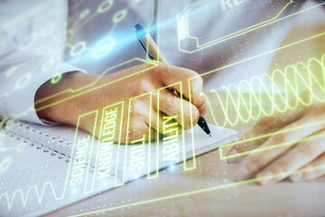 Man's hands working with notes background. Modern computer record diagram with virtual mnitor.