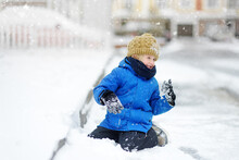 Little Boy Having Fun Playing With Fresh Snow. Active Outdoors Leisure For Child In Snowy Winter Day.