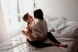 © Thais Varela/Stocksy - attractive couple caressing on bed in the morning