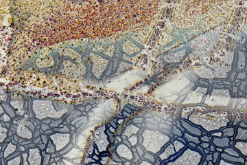 Close macro photograph of layer of color and patterns in glass paperweight, inverted colors