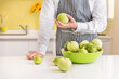 © Lawren Lu/Stocksy - Young man's hands holding guava fruit in kitchen.