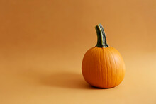 Close Up Shot Of A Single Classic Orange Pumpkin Isolated On Bright Background As A Symbol Of Autumnal Holidays With A Lot Of Copy Space For Text.