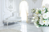 Fototapeta Kwiaty - luxury royal posh interior in baroque style. very bright, light and white hall with expensive oldstyle furniture. large windows and stucco ornament decorations on the walls