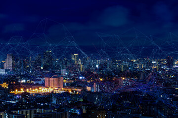 Wall Mural - Modern city with wireless network connection and city scape concept.Wireless network and Connection technology concept with city background at night.