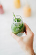 © Pixel Stories/Stocksy - Woman holding green smoothie