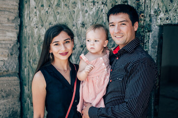 Young family with a beautiful little daughter on castle excursion