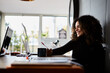 © Guille Faingold/Stocksy - Beautiful smiling student with afro at desk.