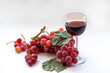 © mylasa - Red grapes and red wine in a glass on a white background