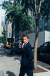 © HEX./Stocksy - Businessman On the Phone Walking in Manhattan Heading To Work ,