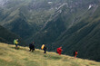 © MIQUEL LLONCH/Stocksy - Happy backpackers on a rainy day