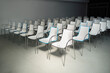 © Lea Csontos/Stocksy - Lecture room full of white chairs