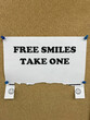 © Carolyn Lagattuta/Stocksy - Homemade sign saying Free Smiles