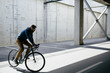 © ALEKSANDAR NOVOSELSKI/Stocksy - Bicyclist in urban environment
