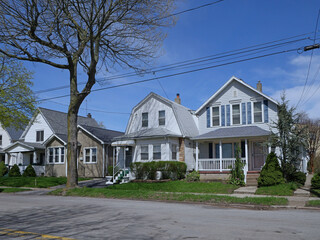 Sticker - Residential street with modest detached houses with aluminum siding or clapboard