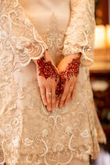 a bride put on henna on her hand on her wedding day