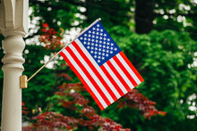 American Flag Displayed On A Porch Post