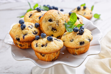 Sticker - Blueberry muffins on a white cake stand, close-up