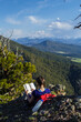 © Blue Mountain Thyme/Stocksy - Woman sits on the side of a mountain reading a book in Montana's Rocky Mountains