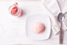 Top View Of Pink Ice Cream Scoop On White Plate