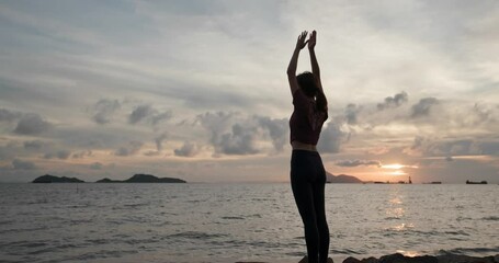 Wall Mural - Woman do yoga and sit beside the sea