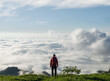 © Ibex.media/Stocksy - Hiker on top of mountain admiring the sea of clouds