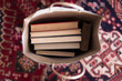 © Jacqui Miller/Stocksy - A selection of vintage books in a paper bag