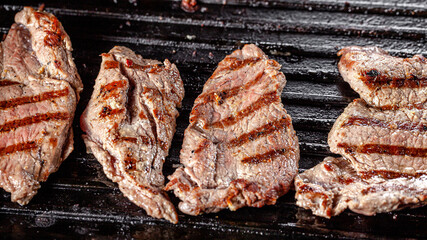 Wall Mural - American cuisine. Fried pork in a cast iron skillet with stripes.