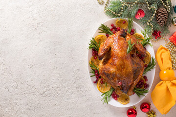 Wall Mural - Christmas table with baked chicken is festively decorated with candles. top view