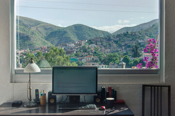 Telecommute remote working office with computer desk and beautiful view