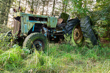 A Rusty Old Disused Tractor In Woodland