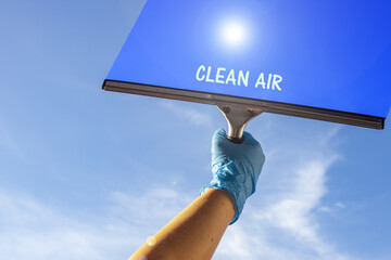 Poster - Person with a glove and rubber scraper for cleaning windows with a â€œCLEAN AIRâ€ text on it