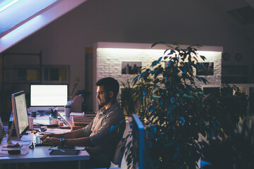Programmer Working at His Office at Night
