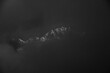 © SHIKHAR BHATTARAI/Stocksy - Dramatic black and white mountains of the himalaya peeking through the clouds.