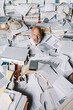 © stokkete - Screaming businessman drowning under a lot of paperwork