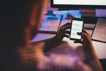 Programmer Looking at a Computer Code on a Smartphone
