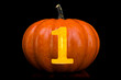 © natatravel - Number 1 carved in pumpkin. Halloween font on black background, 3D rendering